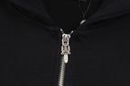 Black hoodie zipper with metal pull tab and hooded neckline hardware