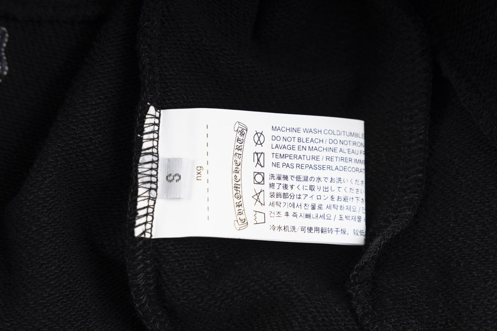 Black long-sleeve hoodie care label inside collar