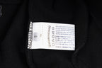 Black long-sleeve hoodie care label inside collar