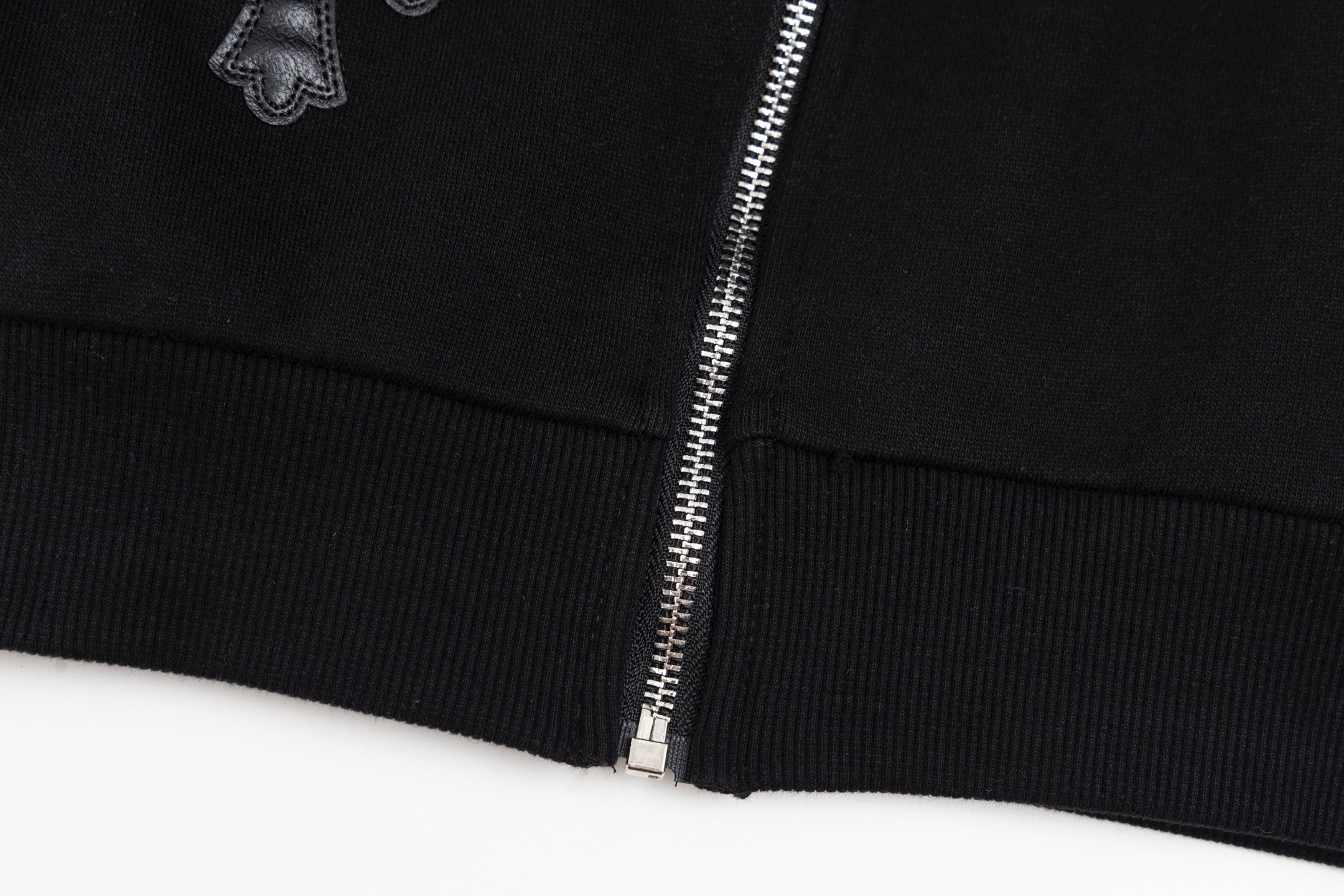 Black hoodie hem cuff with metal zipper and ribbed knit trim