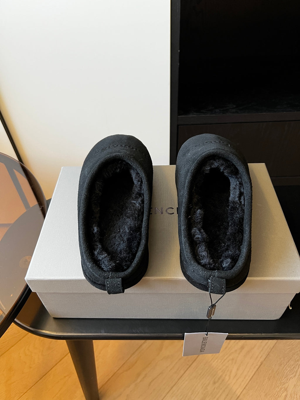 Balenciaga dark suede mules showing open toe and plush lining, boxed pair