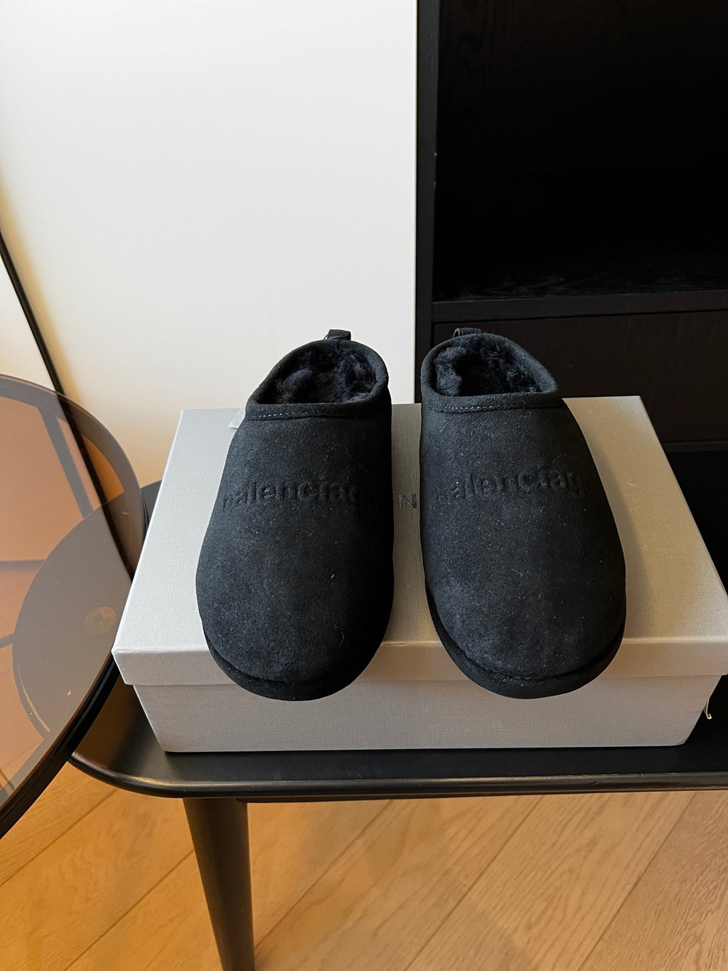 Balenciaga dark suede slip-on mules with plush lining, shown on a box