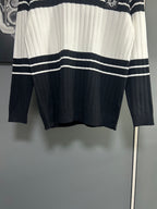 Long-sleeve knit polo sweater hem view with black and white horizontal stripe bands