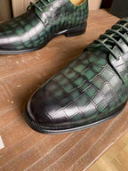 Dior unisex lace-up dress shoes, close-up of green metallic crocodile-pattern leather
