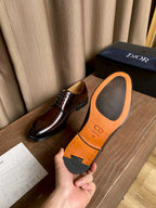 Dior unisex shoes showing orange sole with “CD” logo; dark brown upper