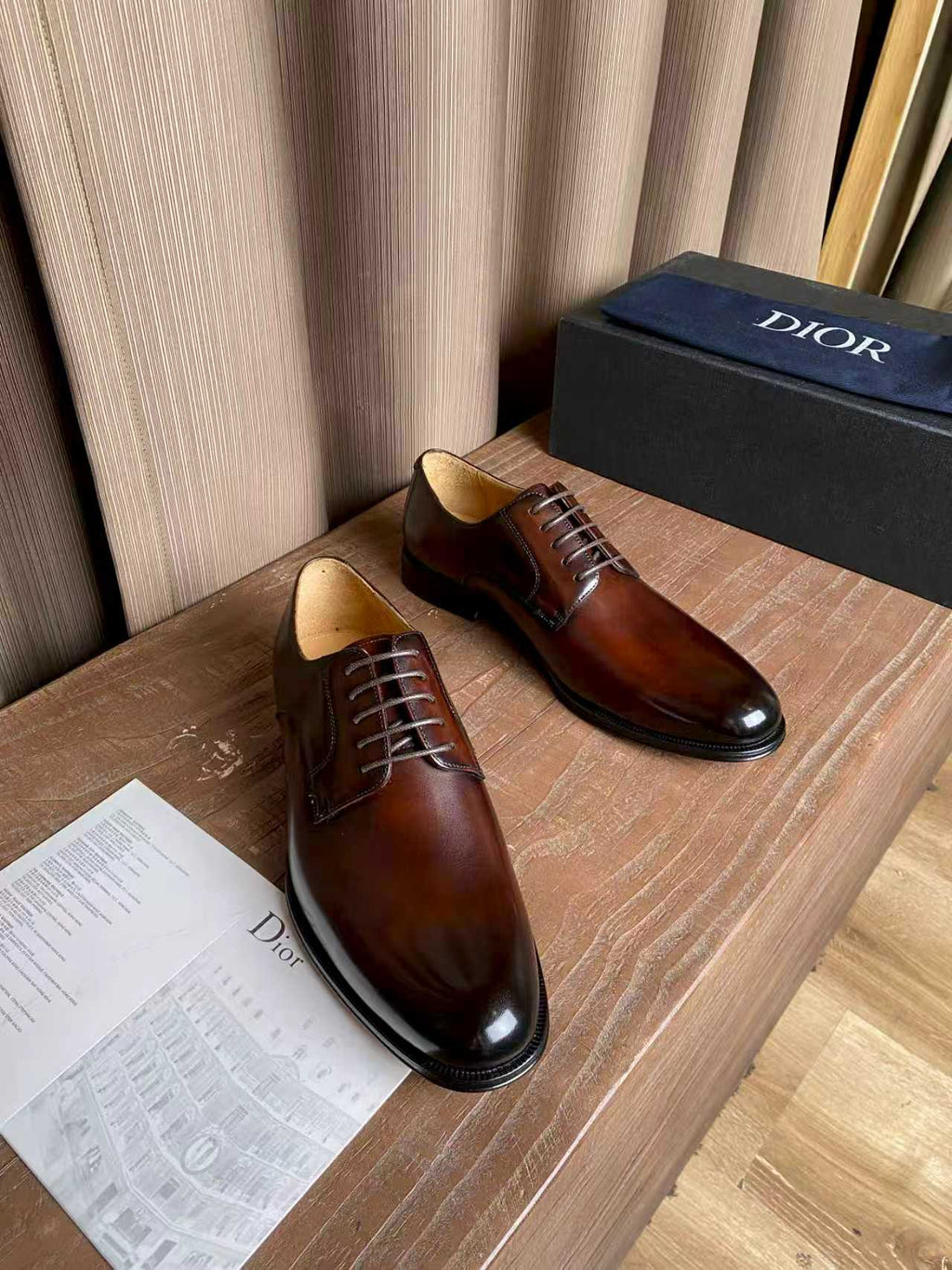 Dior unisex lace-up oxford shoes, dark brown leather on a display surface