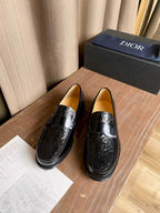 Black leather loafers with embossed ornament panel and silver-tone buckle