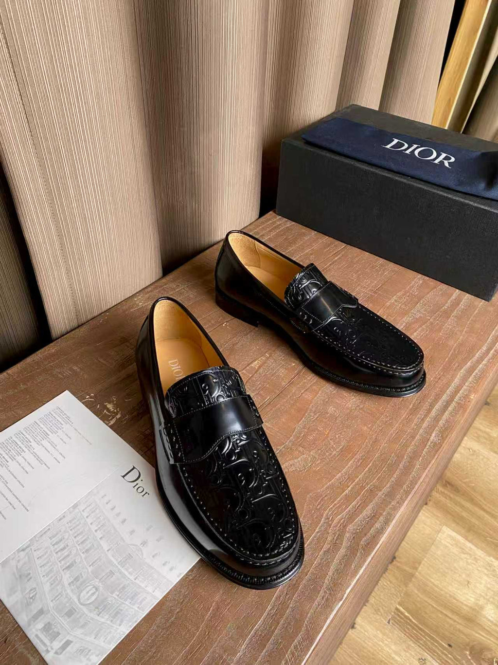 Pair of black leather loafers with embossed panel and silver-tone buckle hardware