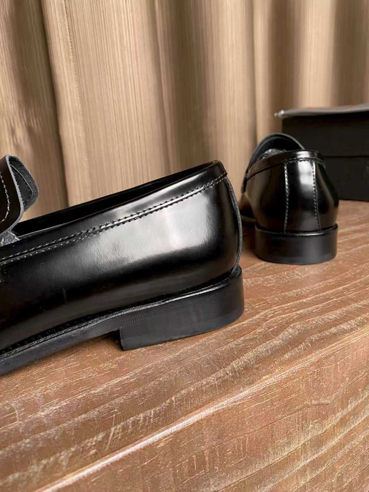 Prada black leather loafer close-up, polished toe and heel with apron stitching