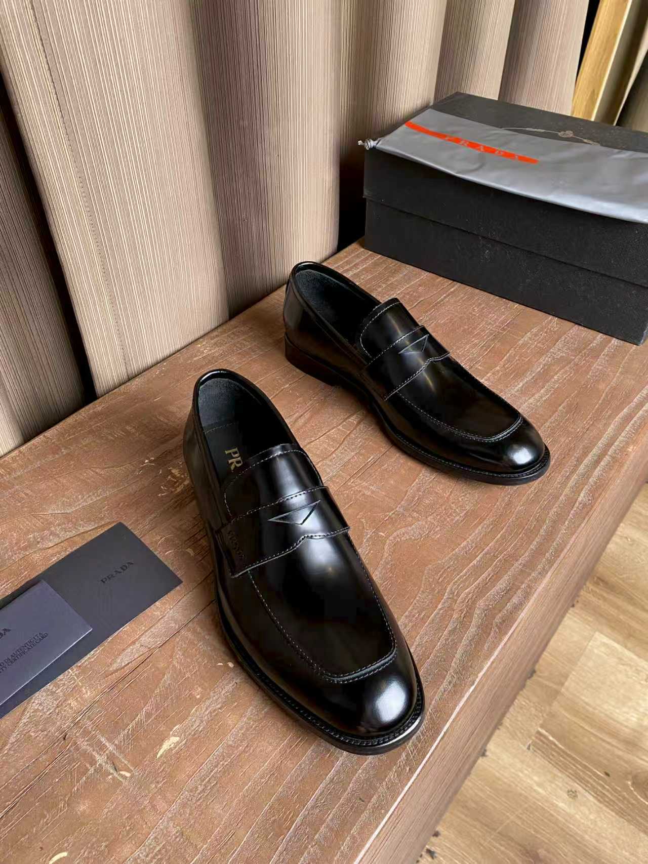 Prada unisex black leather loafers, slip-on design with stitching and low heel