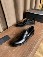Prada unisex black leather loafers, top view showing stitched vamp and low heel