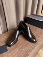 Brown patent leather loafers, rounded toe with apron stitching and thick sole