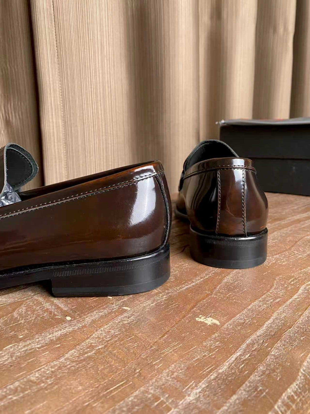 Brown patent leather loafers with low heel, stitched back seam detail