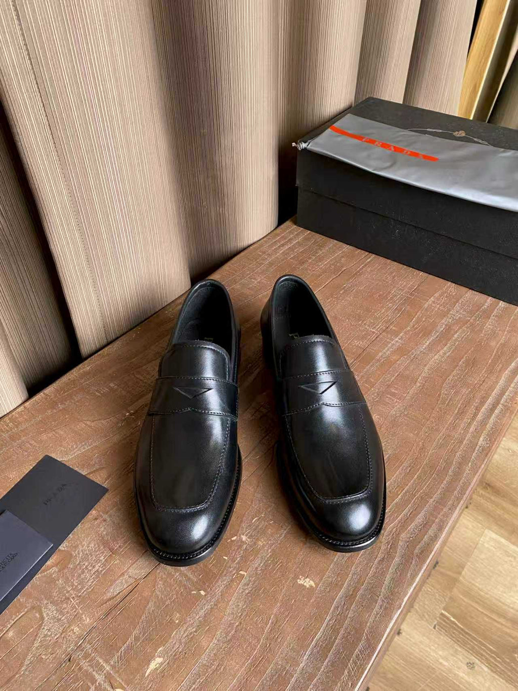 Prada unisex black leather penny loafers, stitched rounded toe and low heel