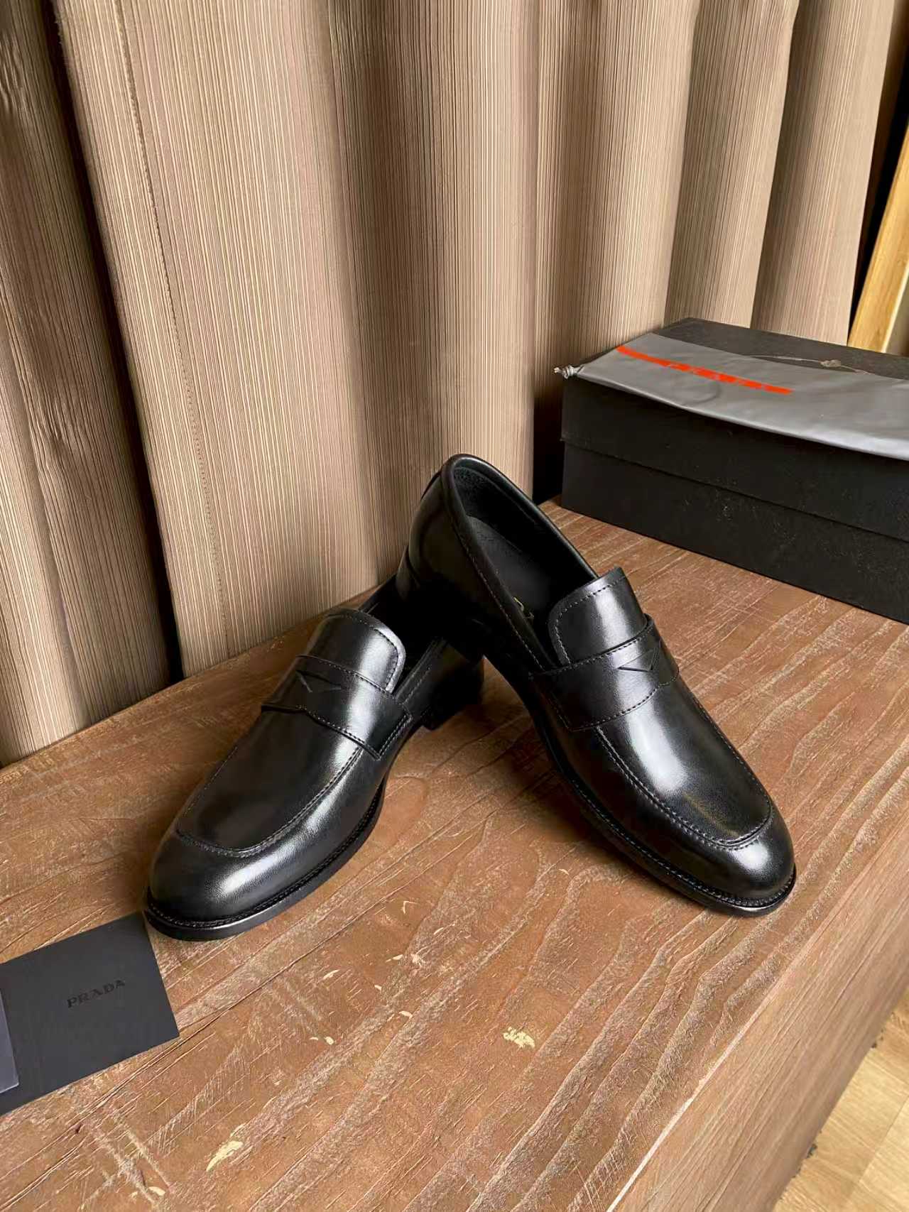 Prada unisex black leather slip-on loafers, rounded toe and stitched seams