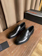 Prada unisex black leather loafers with decorative strap on the vamp