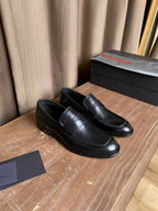 Prada unisex black leather loafers, moc-toe stitching and slip-on style