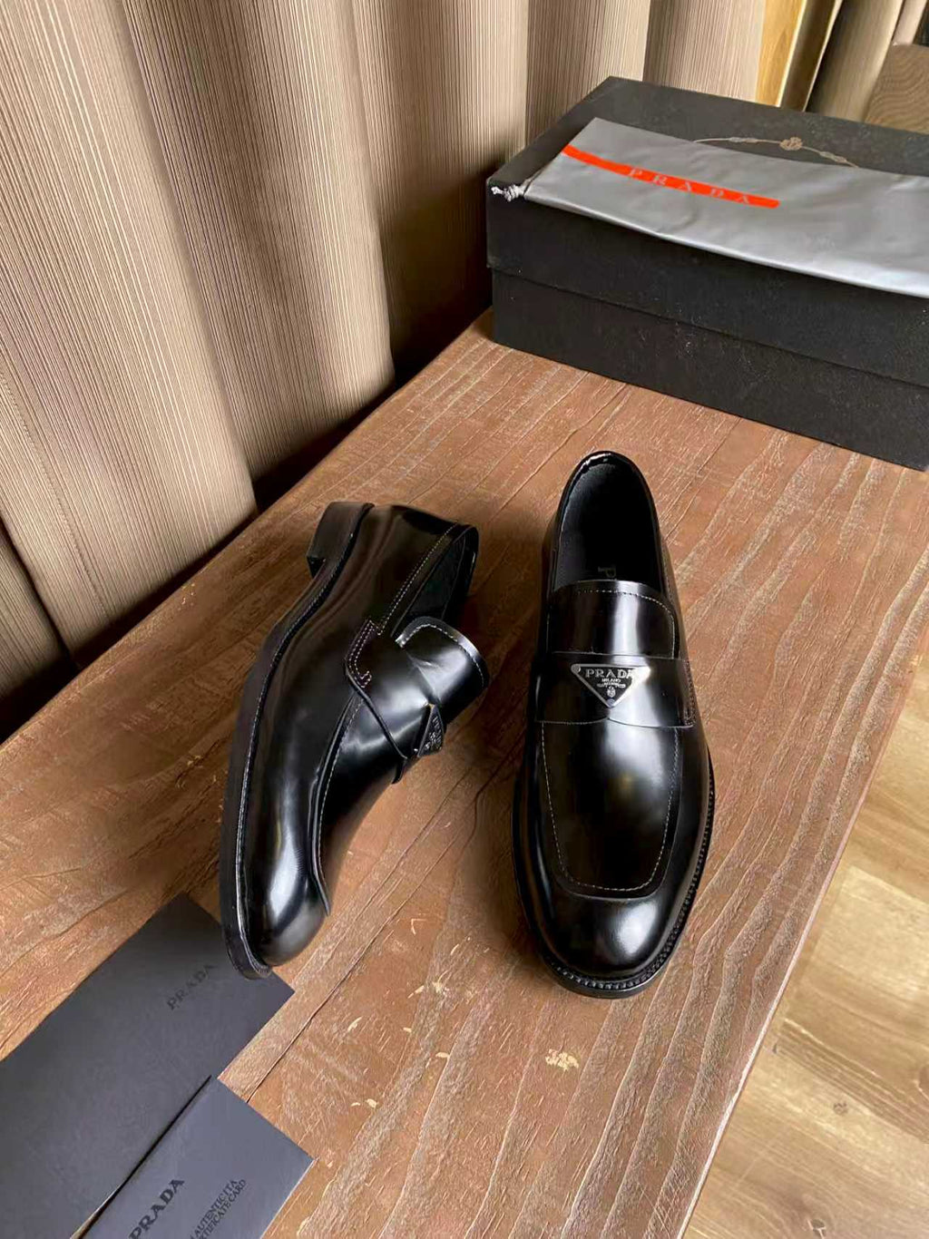 Prada unisex black leather loafers, low heel with slip-on upper and stitched panels