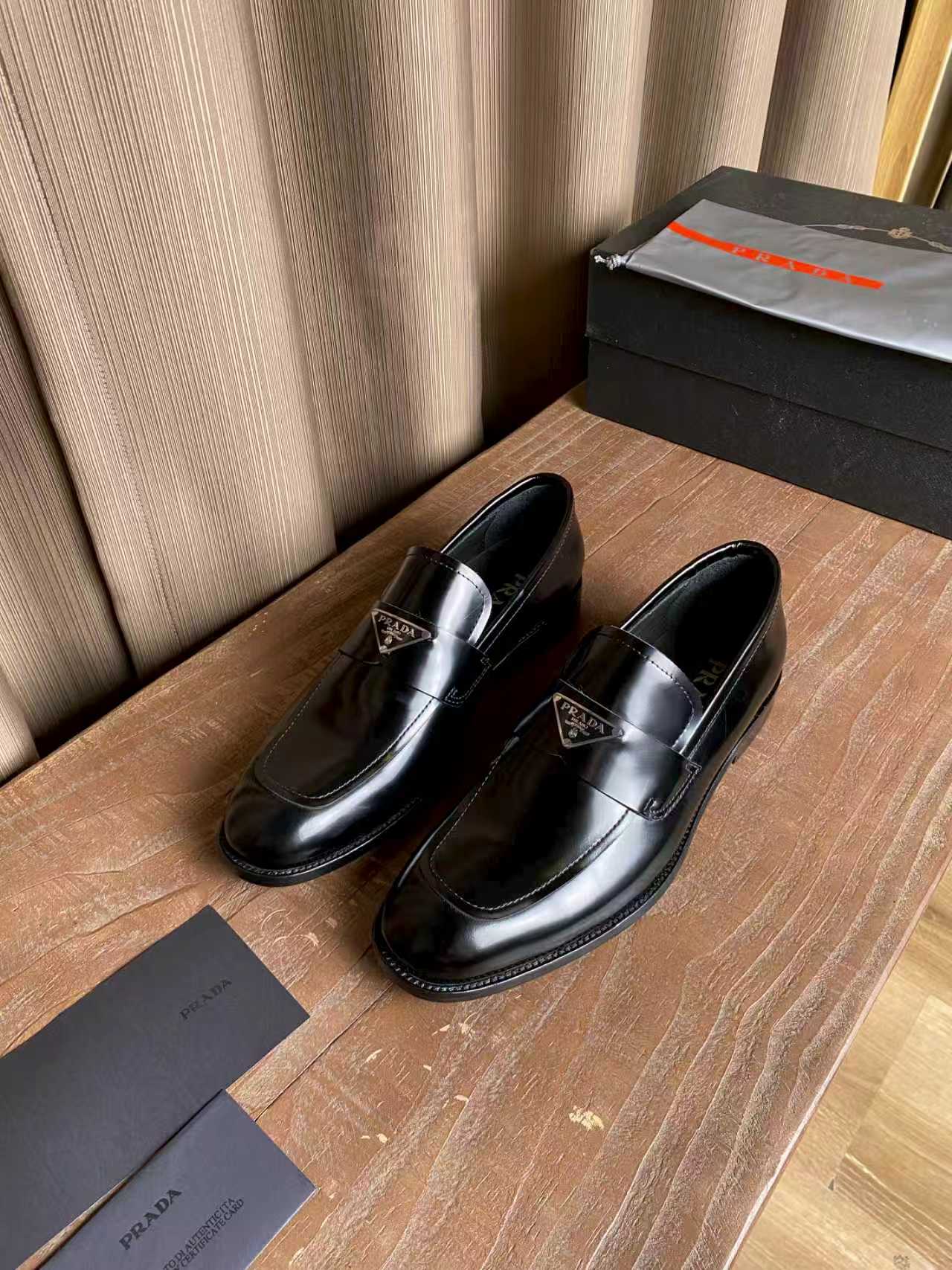 Prada unisex black leather loafers, rounded toe with stitched detailing