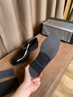Prada unisex black leather loafers, close-up of upper and outsole edge