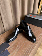 Prada unisex black leather loafers with metal logo detail on the upper