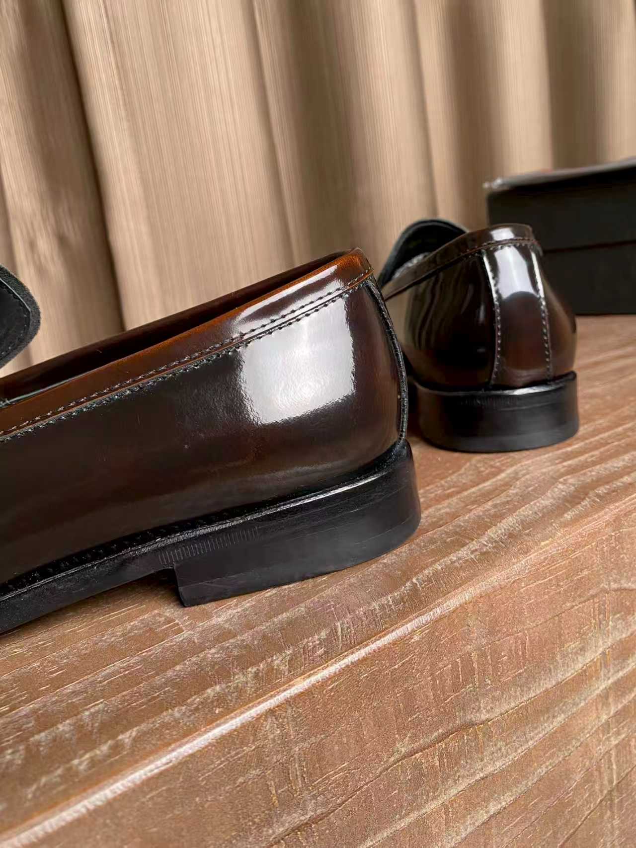 Prada unisex leather loafers, dark brown close-up of glossy vamp and sole edge