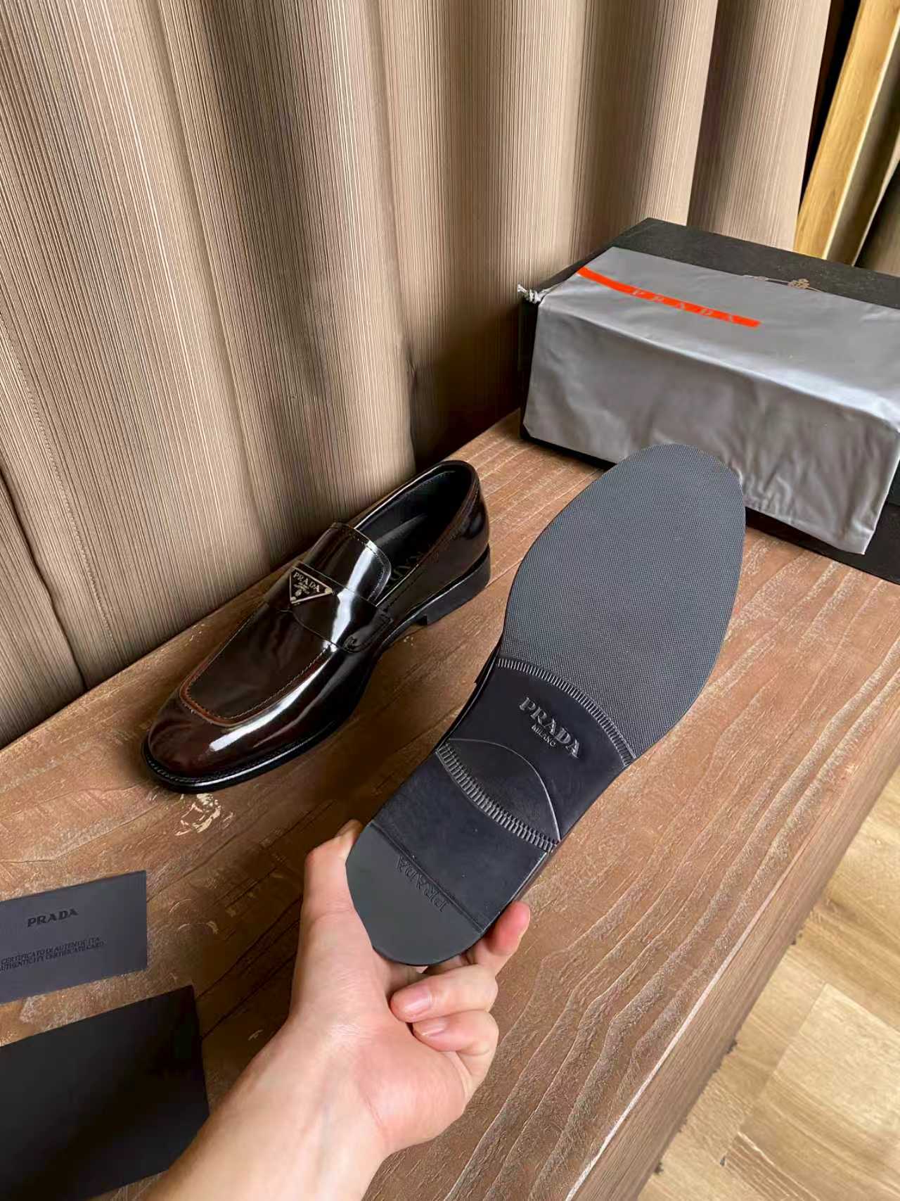 Prada unisex leather loafers, dark brown outsole shown with tread pattern