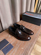 Prada unisex leather loafers, dark brown slip-on style with metal logo detail
