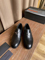 Prada black leather loafers, round toe and front strap detail