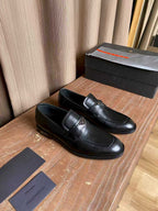 Prada black leather loafers, side view with strap and stitched trim
