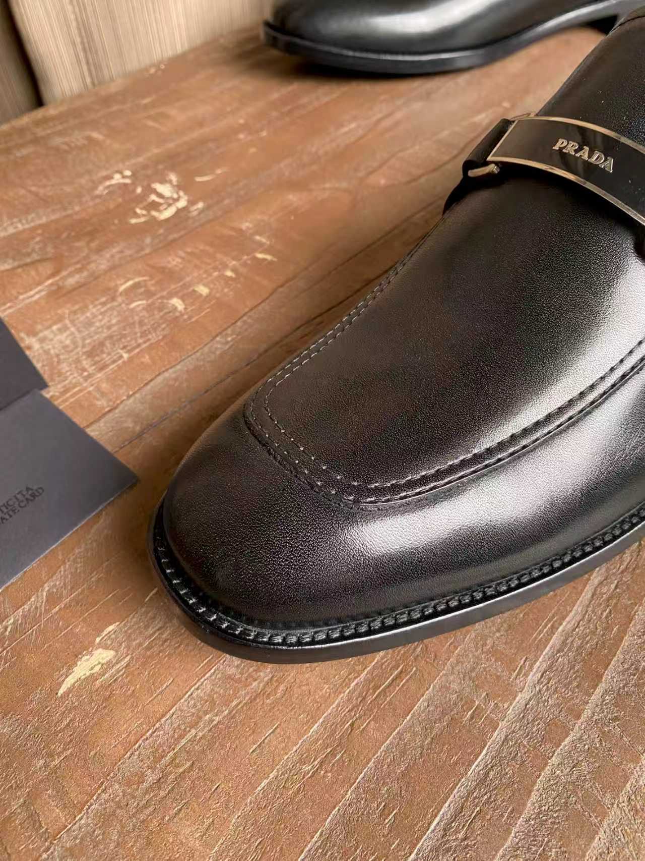 Prada unisex leather loafer toe in dark black with contrast stitching and trim