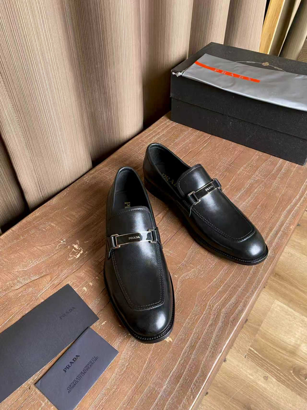 Prada unisex leather loafers, pair in dark black with metal buckle detail