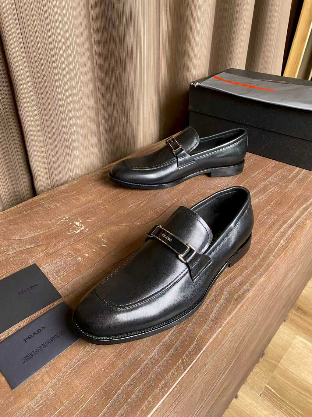 Prada unisex leather loafers, side view with metal buckle strap