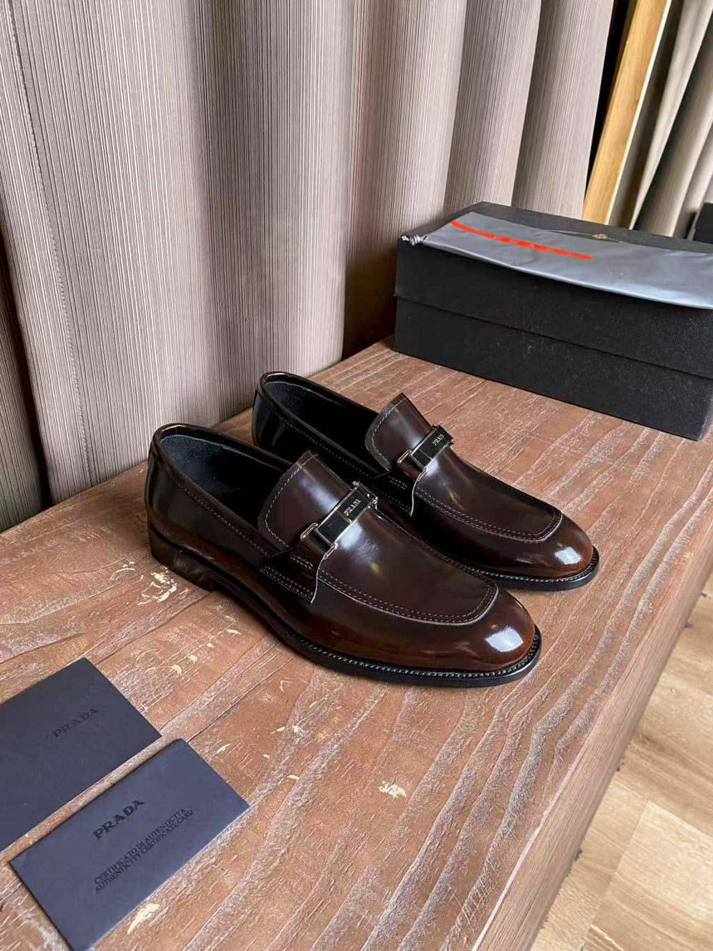 Prada unisex leather loafers, dark brown gloss side view with silver buckle
