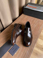 Prada unisex leather loafers, dark brown gloss with silver buckle strap, side angle