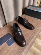 Prada unisex leather loafers, dark brown gloss with silver buckle strap, front angle