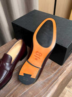Burgundy leather loafers with orange-tan insole and D logo on footbed