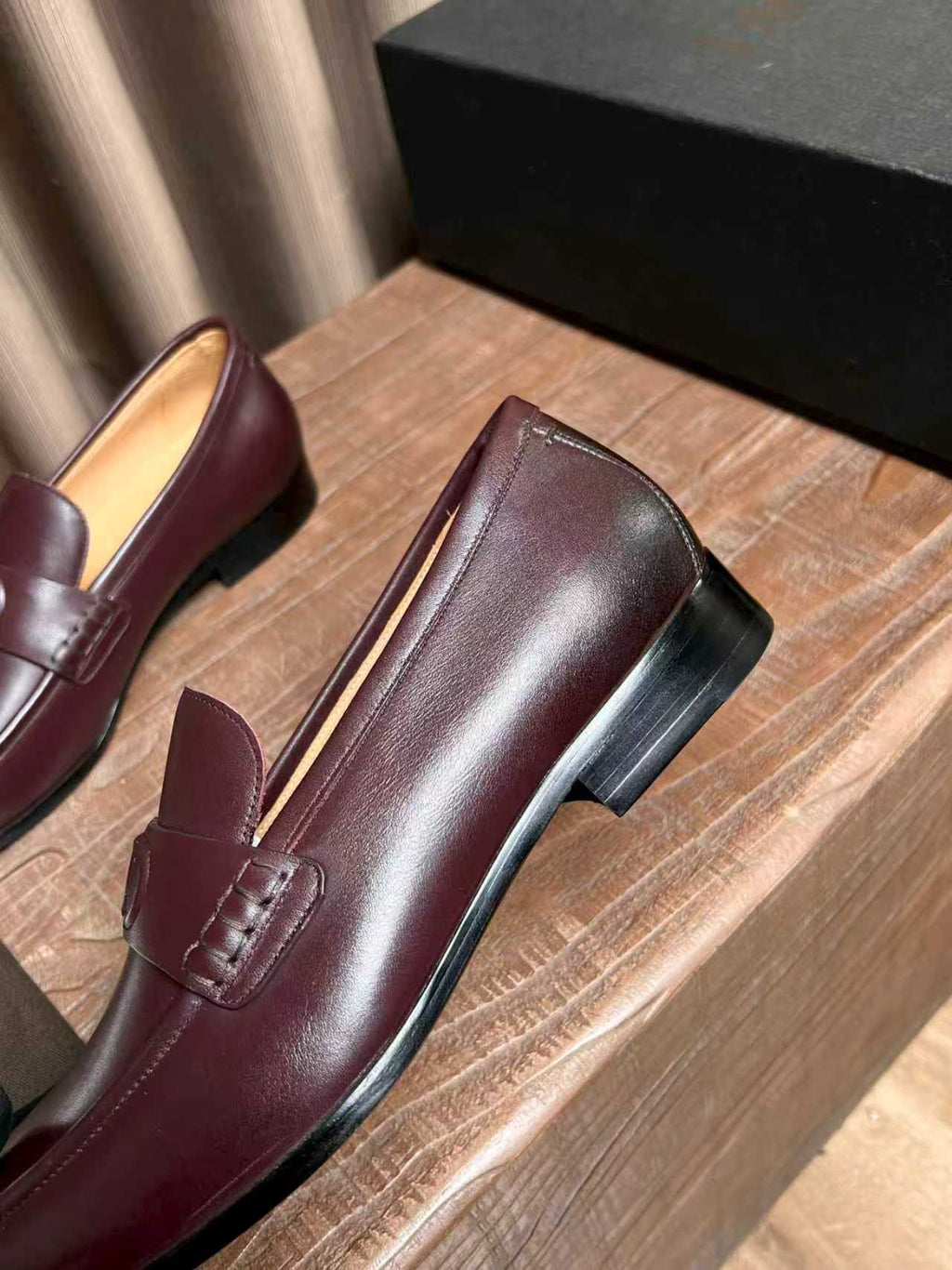 Burgundy leather loafers with stitched front seam and rounded toe