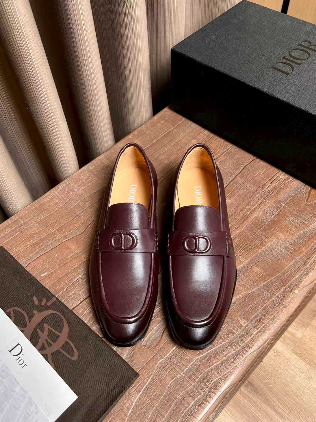 Burgundy leather loafers with Dior logo hardware, slip-on design