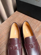 Burgundy leather loafers with tan lining and front D logo hardware