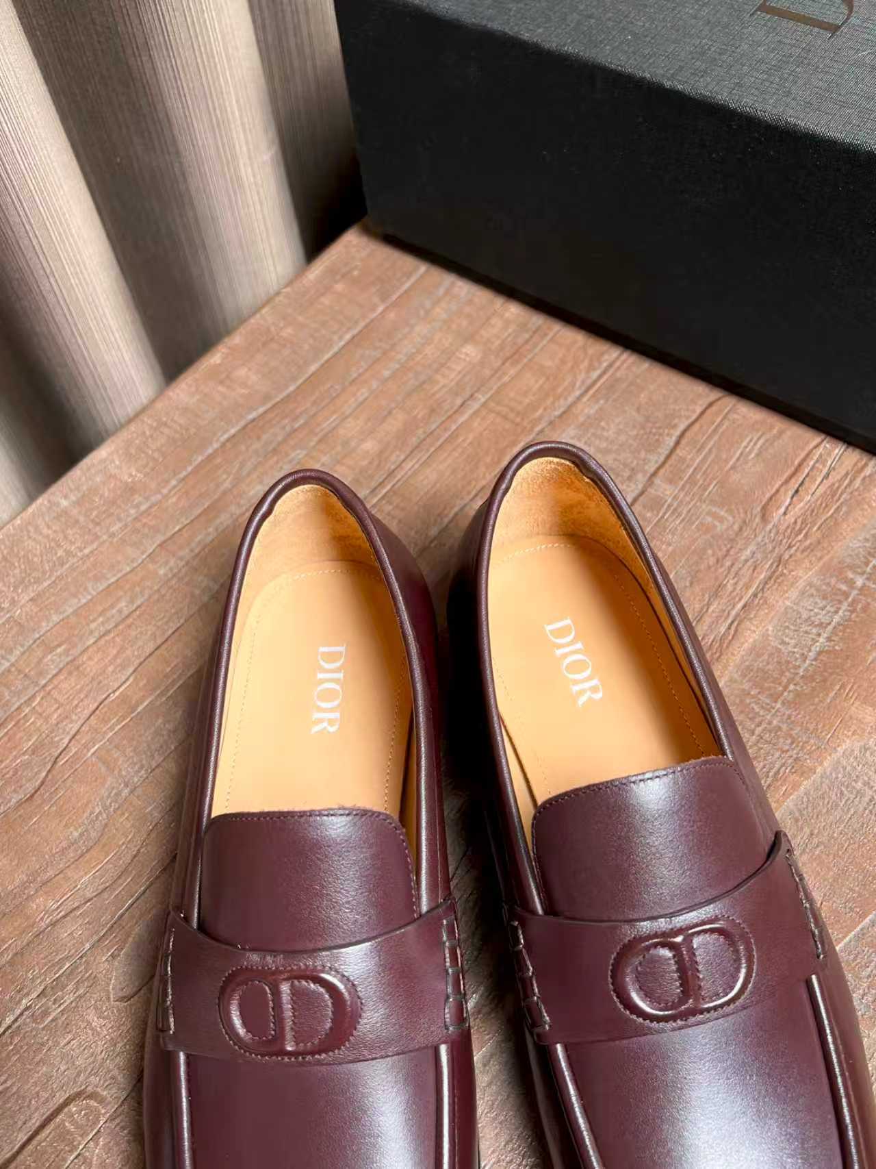 Burgundy leather loafers with tan lining and front D logo hardware