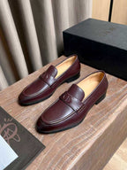 Burgundy leather loafers with rounded toe, front strap and D emblem