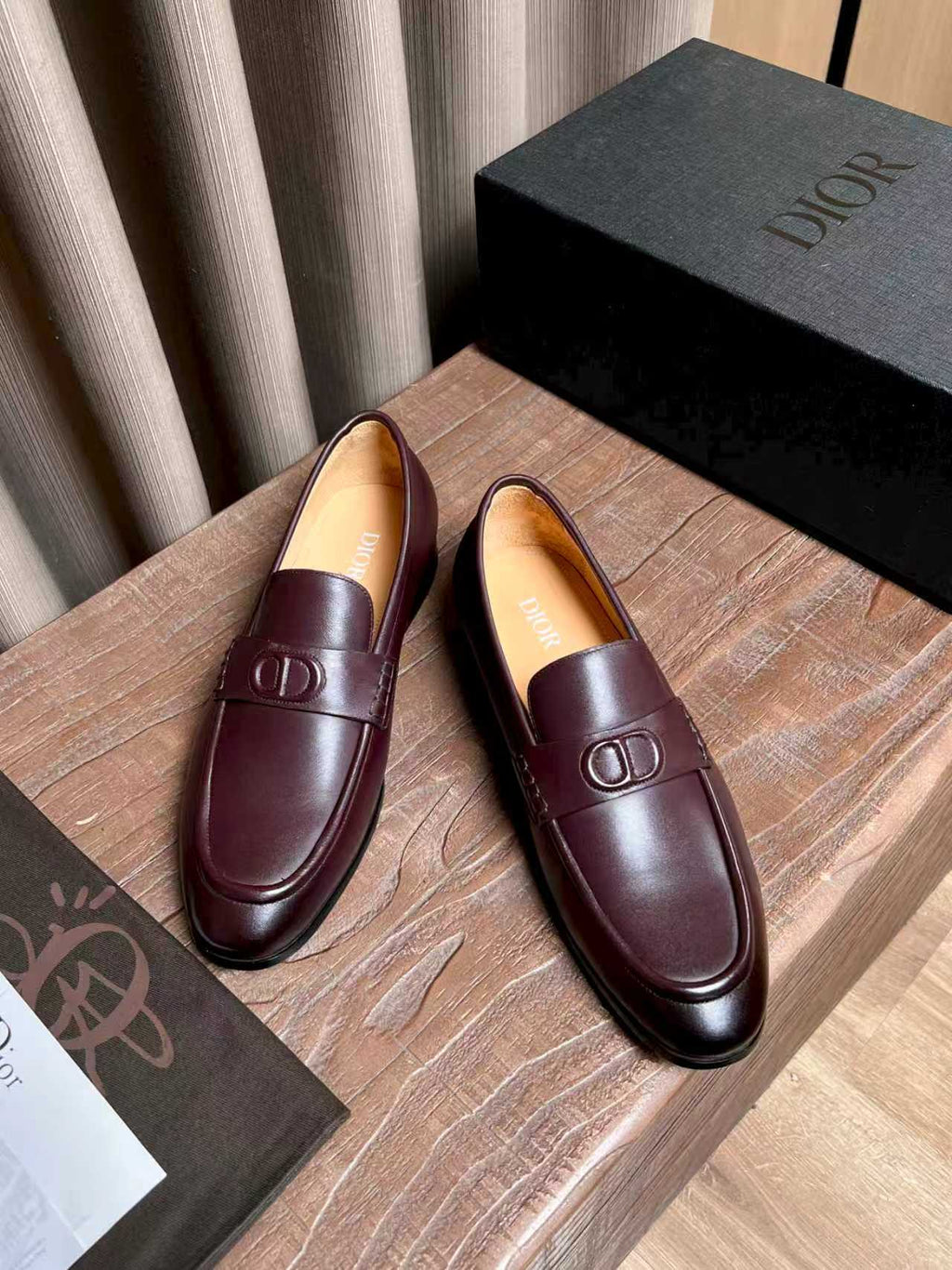 Burgundy leather slip-on loafers with front strap and D logo hardware