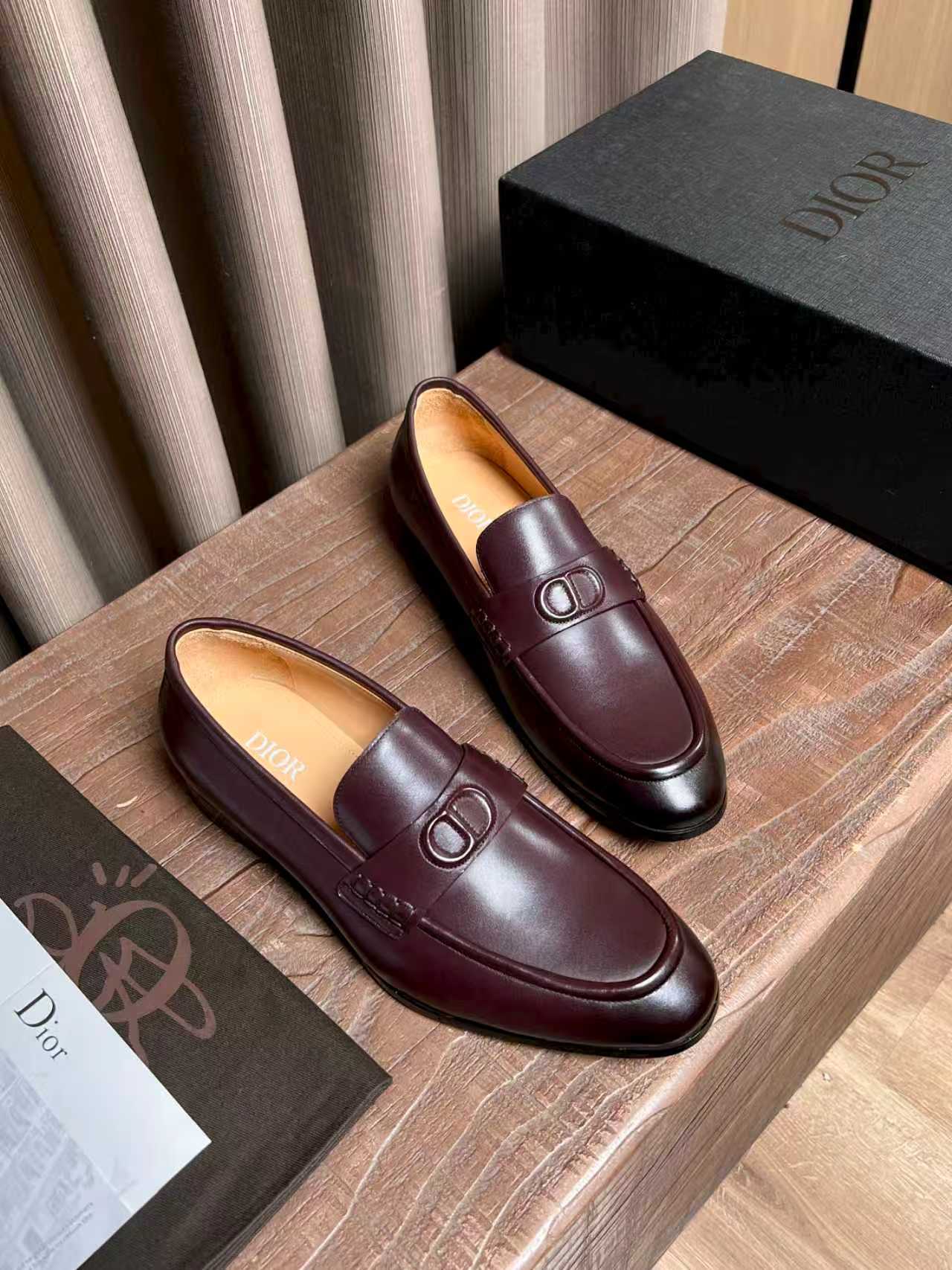Pair of burgundy leather loafers with front D-shaped logo detail