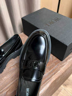 Black patent leather loafer close-up with Dior plaque and rounded toe