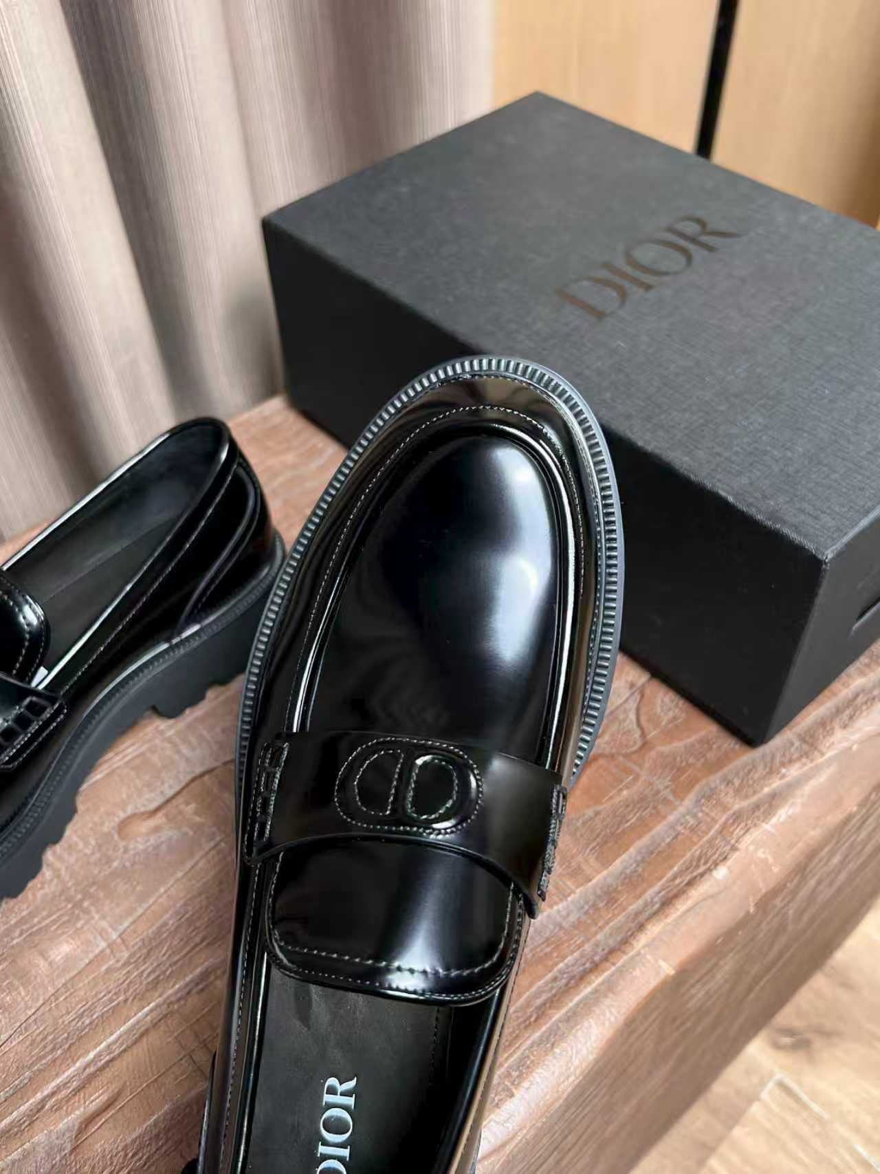 Black patent leather loafer close-up with Dior plaque and rounded toe