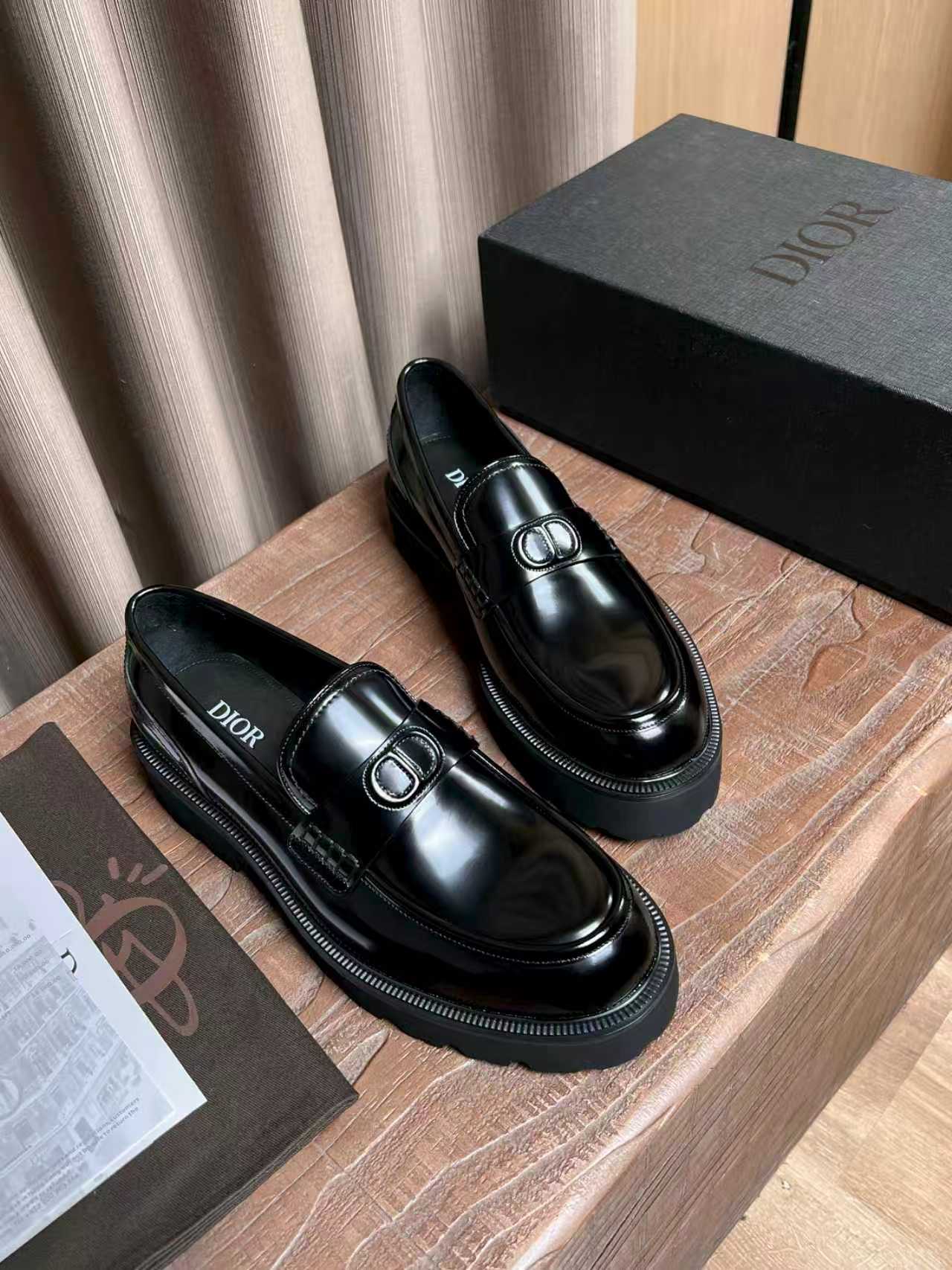 Black patent leather loafers with Dior plaque and textured rubber-look sole