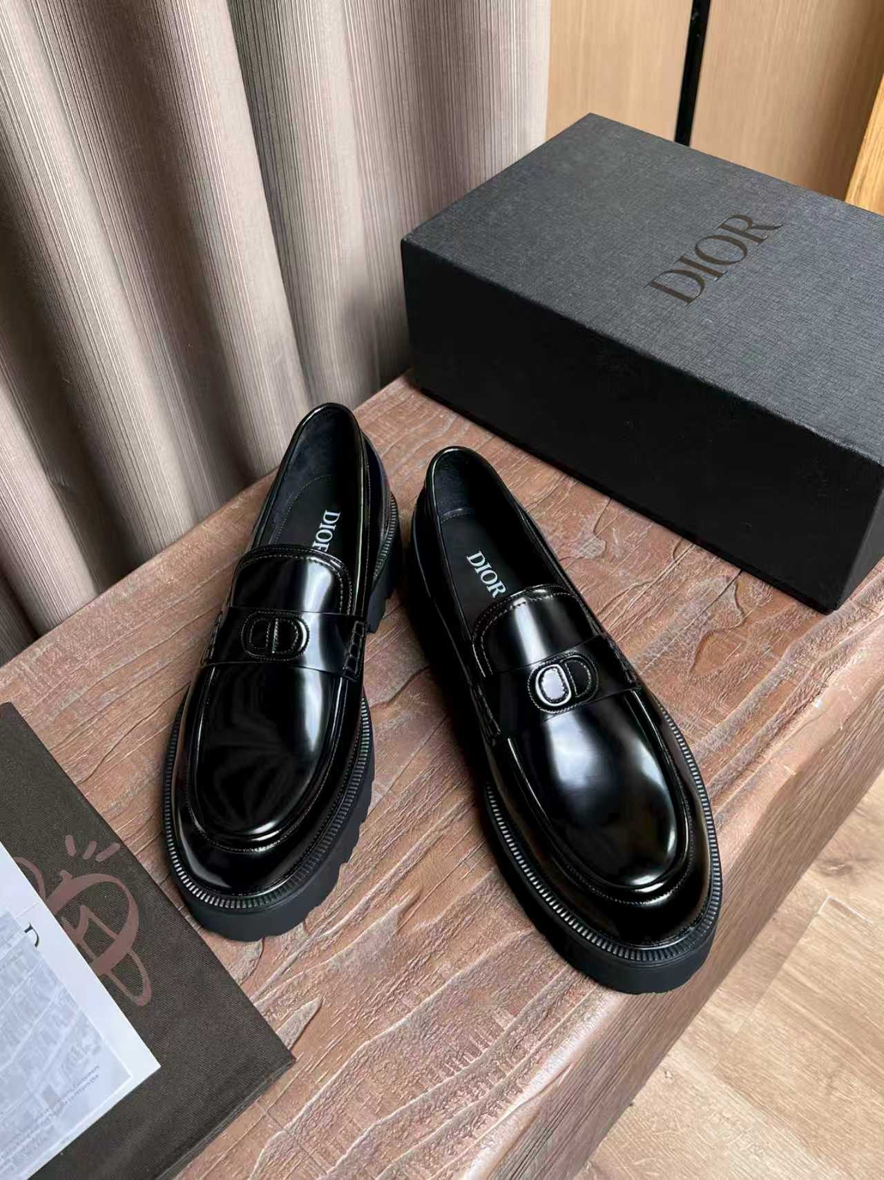 Black patent leather loafers with Dior plaque on the vamp and contrast stitching