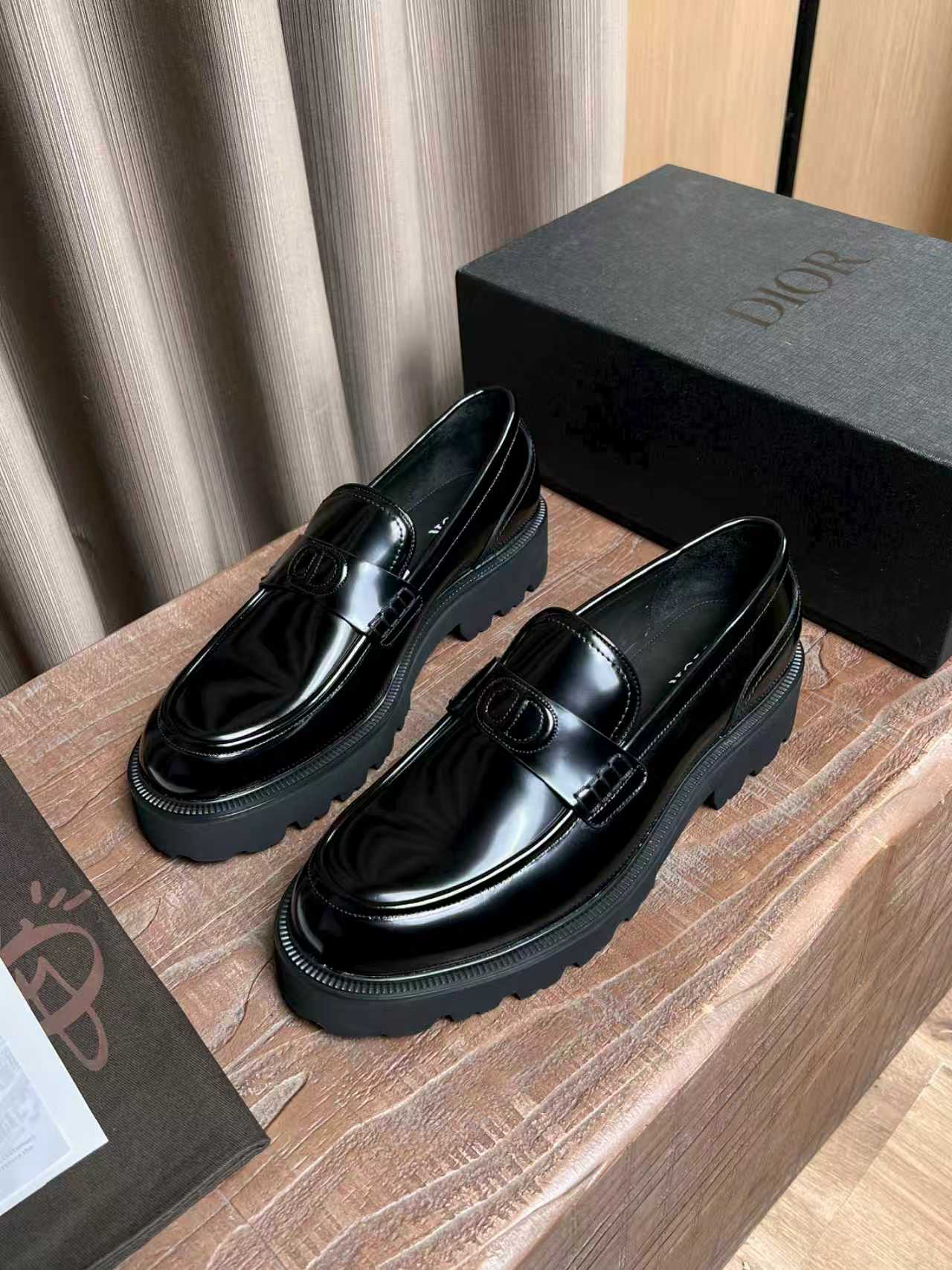 Black patent leather platform loafers with silver buckle ornament and thick sole