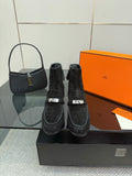 Black women’s ankle boots with buckled straps and low block heels